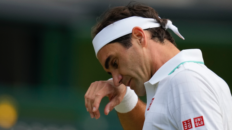 Switzerland's Roger Federer wipes his brow during the men's singles quarterfinals match against Poland's Hubert Hurkacz on day nine of the Wimbledon Tennis Championships. (Kirsty Wigglesworth / AP) 