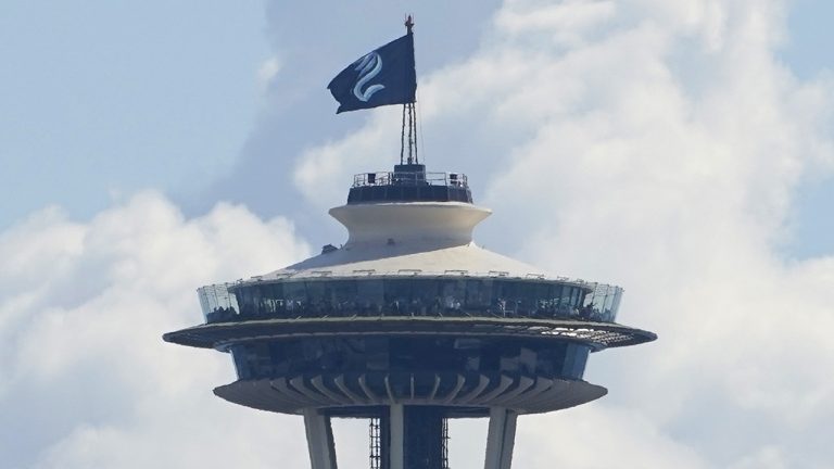 The Seattle Kraken NHL hockey flag flies on top of the Space Needle, Wednesday, July 21, 2021, before the Kraken's expansion draft event. (Ted S. Warren/AP)