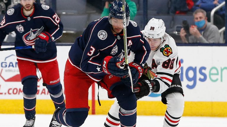 Columbus Blue Jackets' Seth Jones, left, tries to carry the puck past Chicago Blackhawks' Patrick Kane. (AP Photo/Jay LaPrete) 