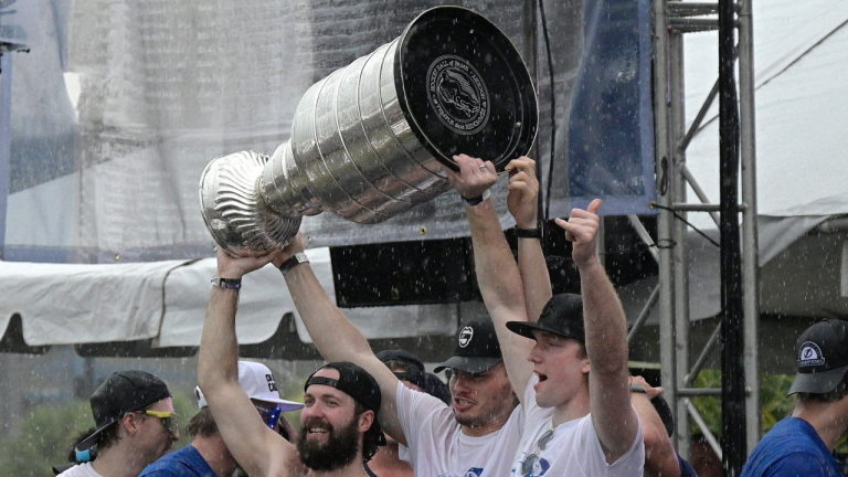 Tampa Bay Lightning right wing Nikita Kucherov, left, defenseman Mikhail Sergachev, center, and goaltender Andrei Vasilevskiy hoist the Stanley Cup during the NHL hockey Stanley Cup champions' championship celebration after their boat parade, Monday, July 12, 2021, in Tampa, Fla. (Phelan M. Ebenhack / AP) 