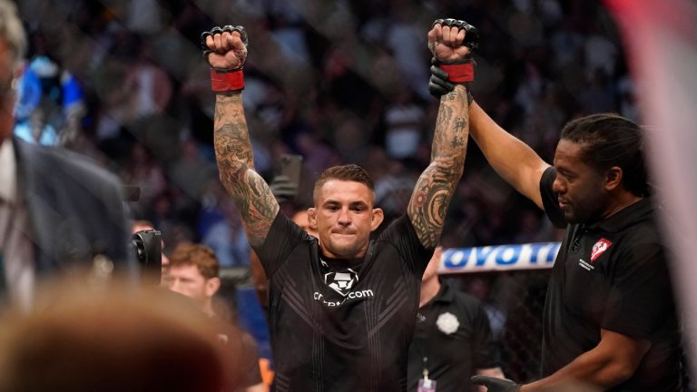 Dustin Poirier is declared the winner after Conor McGregor was injured during a UFC 264 lightweight bout. (John Locher/AP)