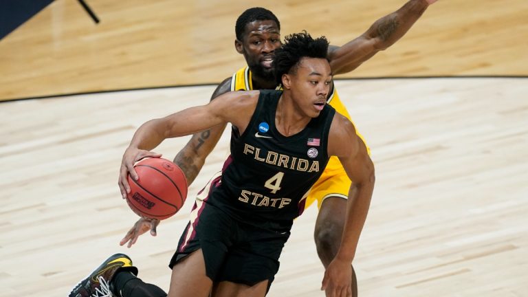 Florida State guard Scottie Barnes (4) drives past Michigan guard Chaundee Brown. (Darron Cummings/AP) 