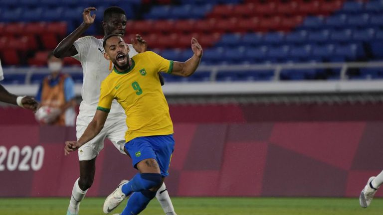 Brazil's Matheus Cunha, right, is fouled by Ivory Coast's Eboue Kouassi during a men's soccer match at the 2020 Summer Olympics. (Kiichiro Sato/AP)