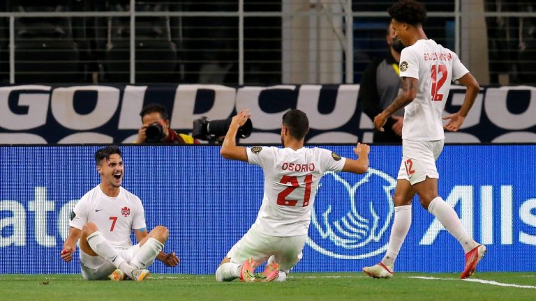 Canada midfielder Stephen Eustaquio (7), Jonathan Osorio (21) and Tajon Buchanan (12) celebrate a goal scored by Eustaquio in the second half of a 2021 CONCACAF Gold Cup quarterfinals soccer match against Costa Rica, Sunday, July 25, 2021, in Arlington, Texas. (Brandon Wade/AP)