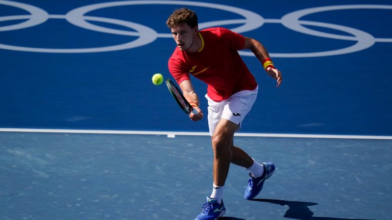 Pablo Carreno Busta, of Spain, returns a shot to Novak Djokovic, of Serbia, during the bronze medal match of the tennis competition at the 2020 Summer Olympics, Saturday, July 31, 2021, in Tokyo, Japan. (Seth Wenig/AP)