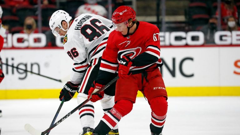 Carolina Hurricanes' Morgan Geekie (67) and Chicago Blackhawks' Mike Hardman (86) compete for the puck during the third period of an NHL hockey game in Raleigh, N.C., Thursday, May 6, 2021. (Karl B DeBlaker/AP) 