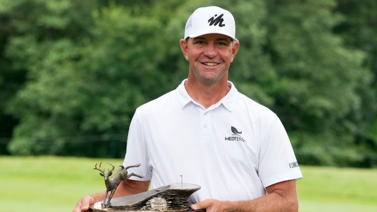 Lucas Glover holds the trophy after winning the John Deere Classic golf tournament, Sunday, July 11, 2021, at TPC Deere Run in Silvis, Ill. (Charlie Neibergall/AP) 