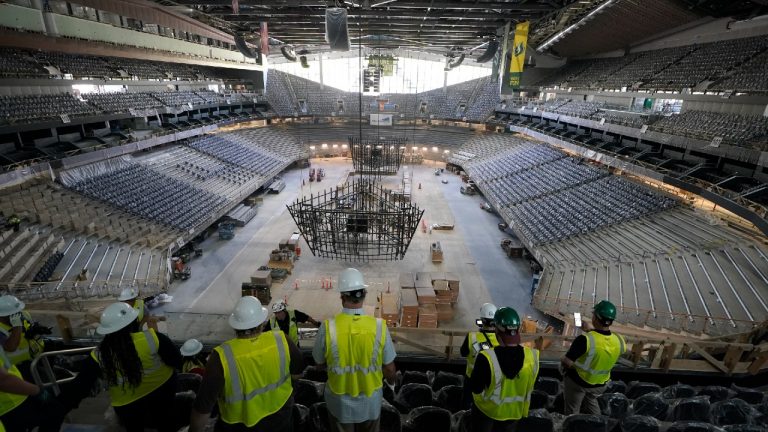 Visitors view the ice and seating areas of Climate Pledge Arena during a media tour of the facility, Monday, July 12, 2021, in Seattle. The arena will be the home of the NHL hockey team Seattle Kraken and the WNBA Seattle Storm basketball team as well as hosting concerts and other performing arts events. (Ted S. Warren/AP) 