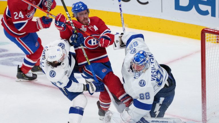 Montreal Canadiens' Brendan Gallagher (11) gets caught in between Tampa Bay Lightning goaltender Andrei Vasilevskiy and teammate Anthony Cirelli during third period Game 3 Stanley Cup finals action in Montreal, Friday, July 2, 2021. THE CANADIAN PRESS/Paul Chiasson 
