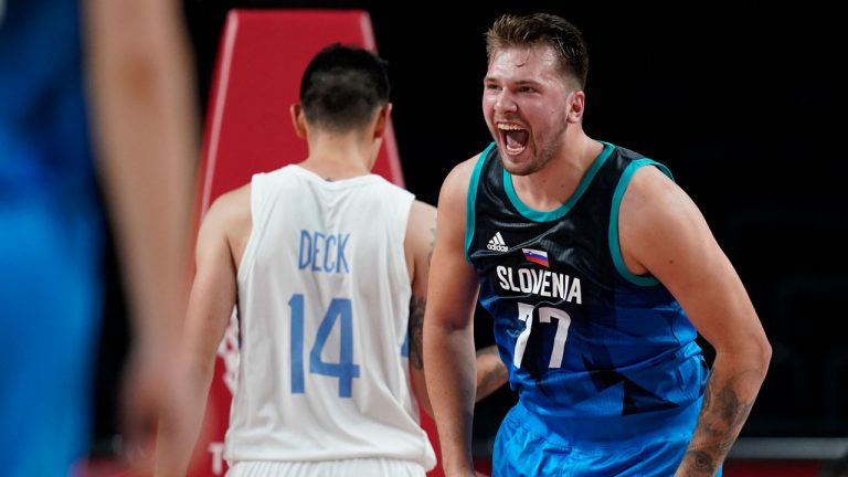 Slovenia's Luka Doncic (77) celebrates after making a basket during men's basketball preliminary round game against Argentina at the 2020 Tokyo Olympics. (Charlie Neibergall/AP) 