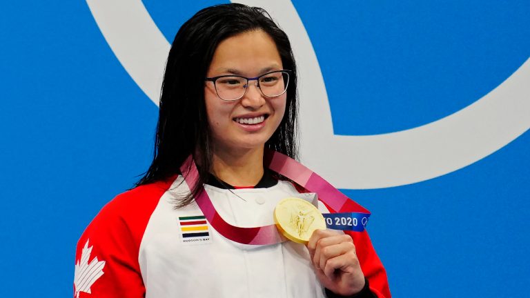 Canada's Margaret Mac Neil celebrates her gold medal in the women's 100m butterfly during the Tokyo Olympics in Tokyo, Japan on Monday, July 26, 2021. (Frank Gunn/CP) 
