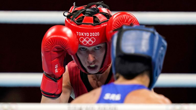 Canada's Mandy Bujold, left, exchanges punches with Serbia's Nina Radovanovic during their women's flyweight 51-kg boxing match at the 2020 Summer Olympics. (Frank Franklin II/AP)