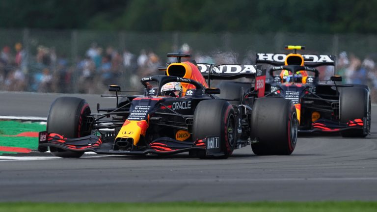 Red Bull driver Max Verstappen of the Netherlands leads teammate Sergio Perez of Mexico, right, into a curve during the first free practice session ahead of Sunday's British Formula One Grand Prix. (Jon Super/AP) 