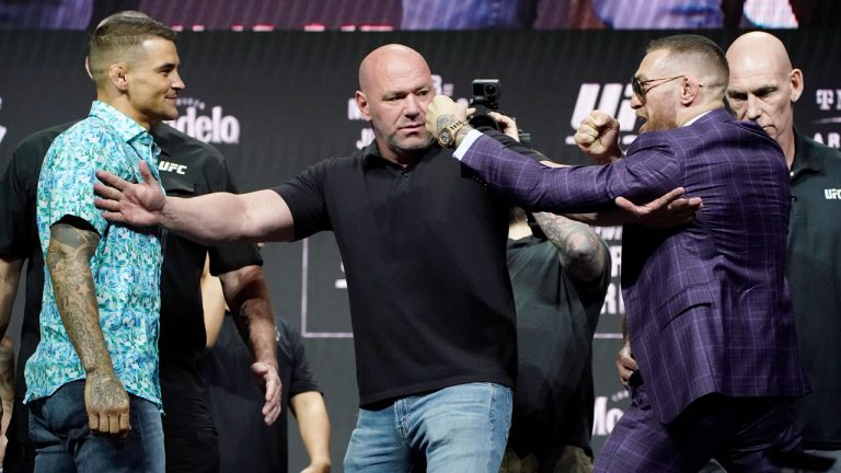 Dana White, center, UFC President, holds Conor McGregor, right, away from Dustin Poirier during a news conference for a UFC 264 mixed martial arts bout. (John Locher/AP) 