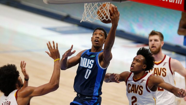 Dallas Mavericks guard Josh Richardson (0) drives for a layup against Cleveland Cavaliers defenders Collin Sexton (2), Jarrett Allen (31) and Dean Wade (32) during the first half of an NBA basketball game, Friday, May 7, 2021, in Dallas. (Brandon Wade/AP)