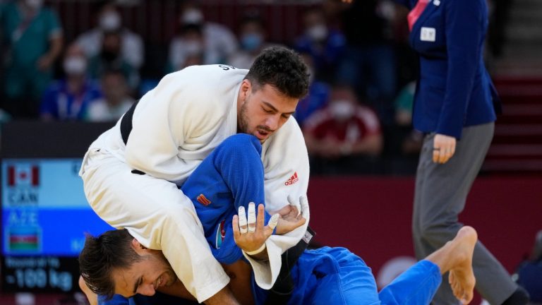 Shady El Nahas, of Canada, top, and Zelym Kotsoiev of Azerbaijian compete in the men's 100kg elimination round judo match of the 2020 Summer Olympics in Tokyo, Japan, Thursday, July 29, 2021. (Vincent Thian/AP)