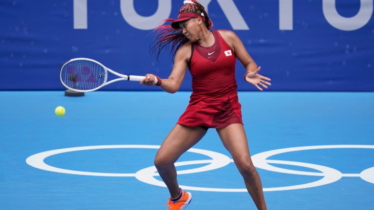 Naomi Osaka, of Japan, returns to Viktorija Golubic, of Switzerland, during second round of the tennis competition at the 2020 Summer Olympics, Monday, July 26, 2021, in Tokyo, Japan. (Patrick Semansky/AP) 
