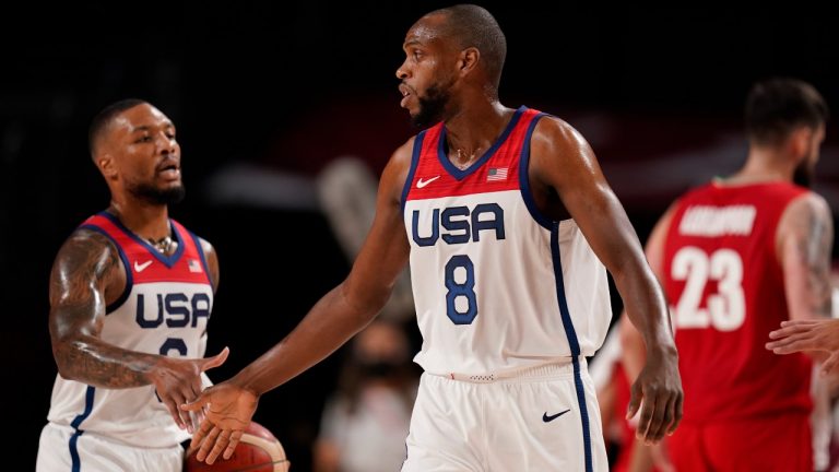 United States' Damian Lillard (6), left, and Khris Middleton (8) celebrate at the end of first quarter during men's basketball preliminary round game against Iran at the 2020 Summer Olympics, Wednesday, July 28, 2021, in Saitama, Japan. (Charlie Neibergall/AP)