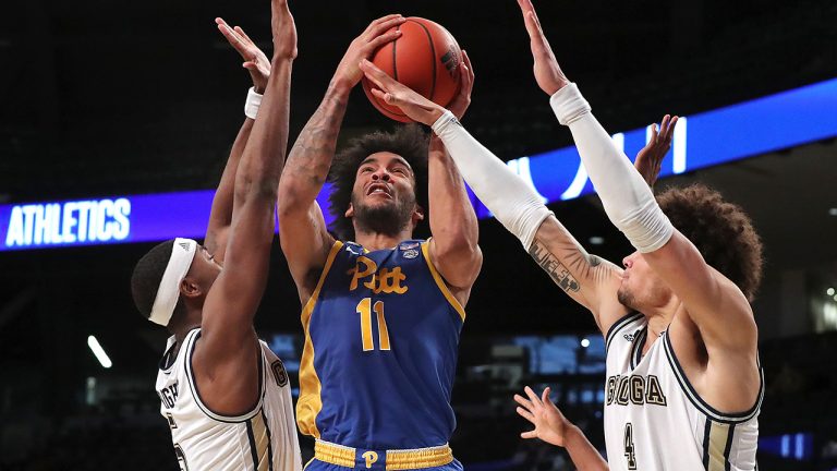 Georgia Tech's Moses Wright, left, and Jordan Usher, right, double team Pittsburgh forward Justin Champagnie, center, during an NCAA college basketball game on Sunday, Feb. 14, 2021, in Atlanta. Georgia Tech beat Pittsburgh 71-65. (Curtis Compton/Atlanta Journal-Constitution via AP)