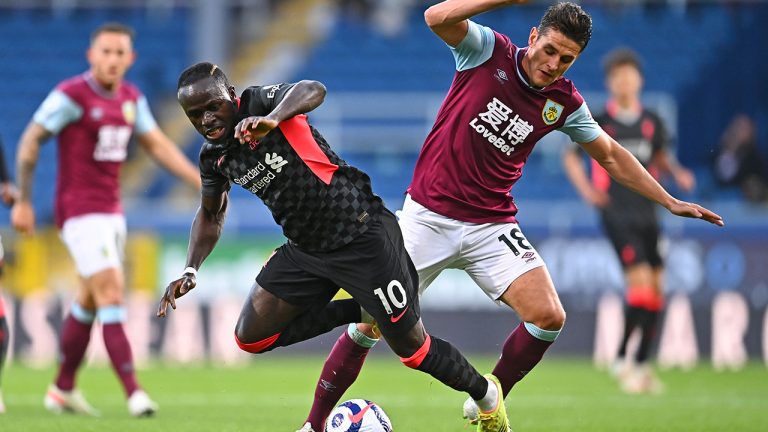 Liverpool's Sadio Mane, left, is fouled by Burnley's Ashley Westwood during the English Premier League soccer match between Burnley and Liverpool at Turf Moor in Burnley, England, Wednesday May 19, 2021. (Clive Mason/Pool via AP)