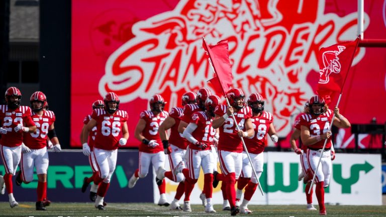 Calgary Stampeders players take to the field to play the Toronto Argonauts. (Jeff McIntosh/CP)