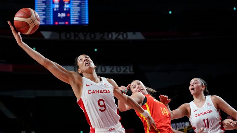 Canada's Miranda Ayim (9), left, grabs a rebound over Spain's Raquel Carrera Quintana (14). (Charlie Neibergall/AP) 