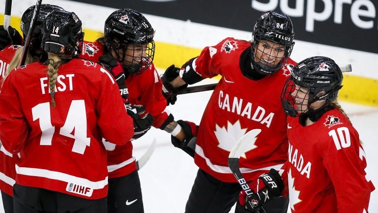 Canada's Natalie Spooner, centre, celebrates her goal with teammates during first period quarterfinal IIHF Women's World Championship hockey action against Germany in Calgary, Saturday, Aug. 28, 2021. (Jeff McIntosh/CP)