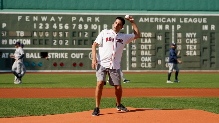 Chris Snow, an assistant general manager for the Calgary Flames, throws out a ceremonial first pitch before the baseball game between the Boston Red Sox and Tampa Bay Rays at Fenway Park, Thursday, Aug. 12, 2021, in Boston. (Mary Schwalm / AP)