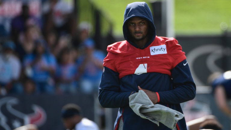 Texans quarterback Deshaun Watson (4) wipes his hands after stretching during NFL football practice Saturday, July 31, 2021, in Houston. (Justin Rex / AP) 