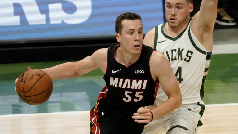 Miami Heat's Duncan Robinson drives past Milwaukee Bucks' Pat Connaughton during the first half of an NBA basketball game Saturday, May 15, 2021, in Milwaukee. (Morry Gash/AP) 