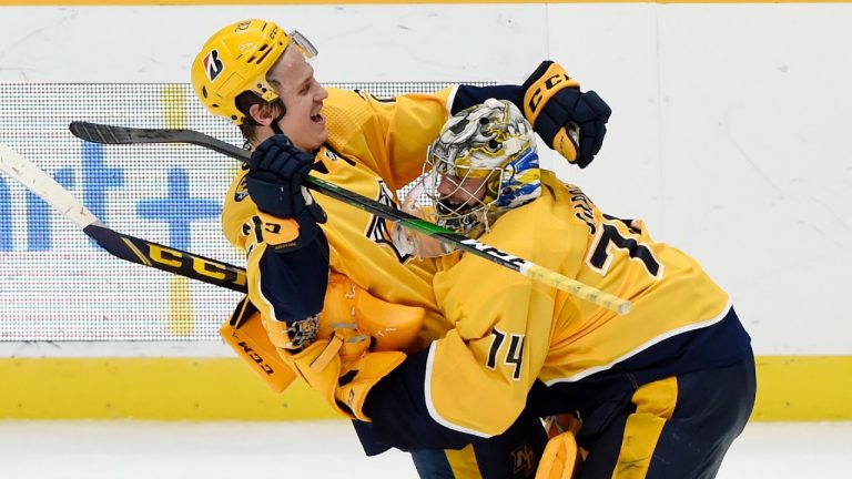 Nashville Predators right wing Eeli Tolvanen (28) celebrates with goaltender Juuse Saros (74) after Tolvanen scored the game-winning goal against the Dallas Stars in overtime of an NHL hockey game Tuesday, March 30, 2021, in Nashville, Tenn. The Predators won 3-2 (Mark Zaleski/AP).