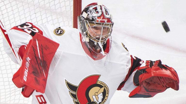 Ottawa Senators goaltender Filip Gustavsson makes a save against the Montreal Canadiens during first period NHL hockey action. (Graham Hughes/CP)