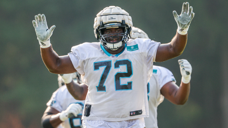 Carolina Panthers tackle Taylor Moton wears a Guardian Cap over his helmet to provide an extra layer of protection during practice at the NFL football team's training camp in Spartanburg, S.C., Tuesday, Aug. 10, 2021. (Nell Redmond / AP) 