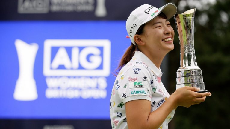 Japan's Hinako Shibuno reacts as she holds the trophy as she celebrates after winning the Women's British Open golf championship at Woburn Gold Club near near Milton Keynes, England (Tim Ireland/AP). 
