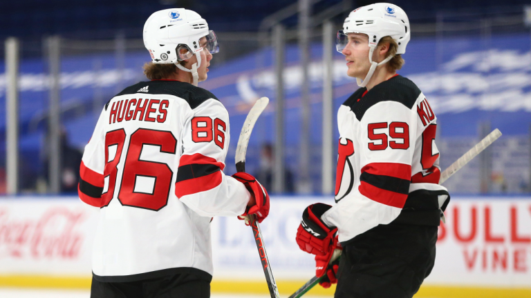 New Jersey Devils forward Jack Hughes (86) celebrates his goal with forward Janne Kuokkanen (59) during the first period of the team's NHL hockey game against the Buffalo Sabres, Thursday, April 8, 2021, in Buffalo, N.Y. (Jeffrey T. Barnes / AP) 