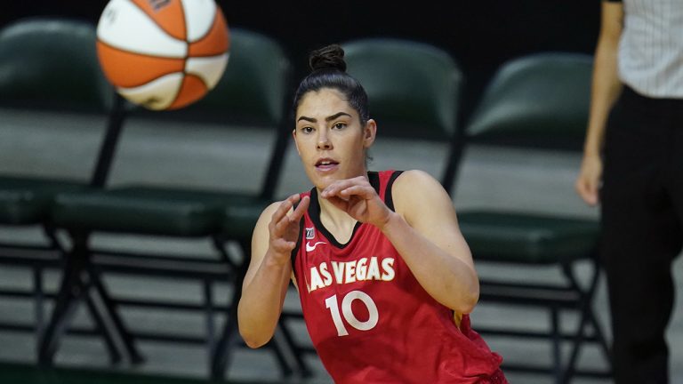 Las Vegas Aces' Kelsey Plum reaches for the ball during the first half of a WNBA basketball game. (Elaine Thompson/AP)