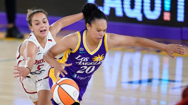 Los Angeles Sparks guard Kristi Toliver, right, dribbles past Washington Mystics guard Leilani Mitchell during the second half of a WNBA basketball game (Marcio Jose Sanchez/AP).