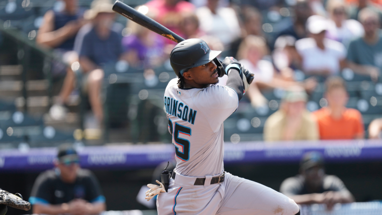 Miami Marlins' Lewis Brinson follows the flight of his double that drove in two runs off Colorado Rockies starting pitcher Kyle Freeland in the fifth inning of a baseball game Sunday, Aug. 8, 2021, in Denver. (David Zalubowski / AP) 