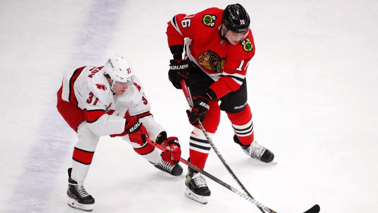 Carolina Hurricanes right wing Andrei Svechnikov (37) and Chicago Blackhawks defenseman Nikita Zadorov (16) vie for the puck during the first period of an NHL hockey game Thursday, April 1, 2021, in Chicago (Jeff Haynes/AP).