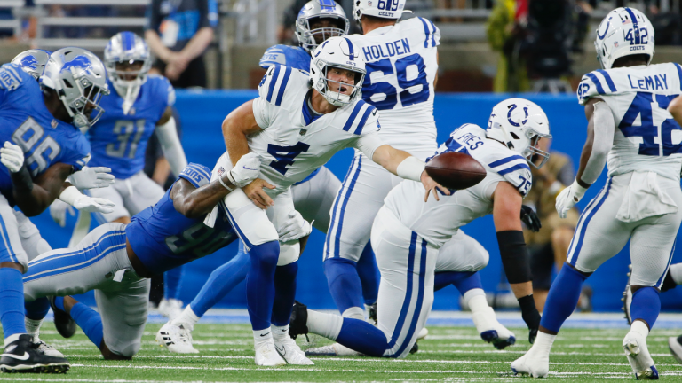 Indianapolis Colts quarterback Sam Ehlinger (4) laterals the ball to running back Benny LeMay (42) after being tackled by Detroit Lions defensive tackle Jashon Cornell during the second half of a preseason NFL football game, Friday, Aug. 27, 2021, in Detroit. (Duane Burleson / AP) 