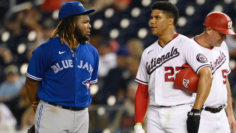 Washington Nationals' Juan Soto (22) talks with Toronto Blue Jays first baseman Vladimir Guerrero Jr., left, after Soto walked during the third inning of a baseball game on Tuesday, Aug. 17, 2021, in Washington. (Nick Wass / AP) 