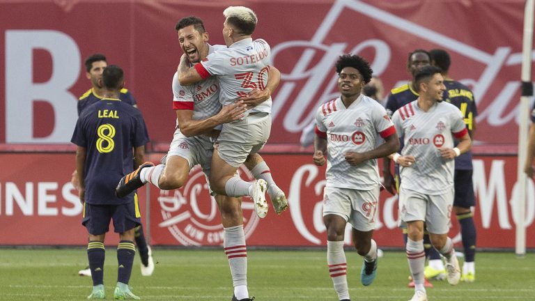 Toronto FC's Omar Gonzalez (centre left) celebrates with Yeferson Soteldo after scoring the game's opening goal during first half MLS    action against Nashville SC, in Toronto on Sunday, August 1, 2021. (Chris Young/CP)