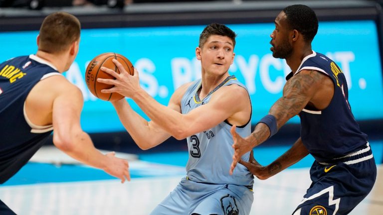 Memphis Grizzlies guard Grayson Allen, center, looks to pass the ball as Denver Nuggets center Nikola Jokic, left, and forward Will Barton defend in the first half of an NBA basketball game Monday, April 19, 2021, in Denver. (David Zalubowski/AP)