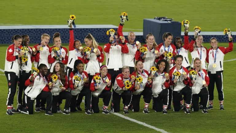 Canadian soccer players pose for a team photo after their win against Sweden in the women's soccer gold medal game at the Tokyo Olympics in Yokohama, Japan on Friday, August 6, 2021. (CP)