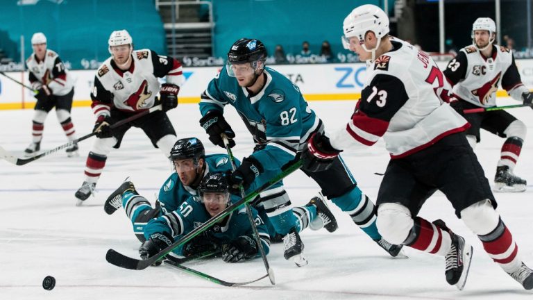 San Jose Sharks left wing Ivan Chekhovich (82) and Arizona Coyotes right wing Jan Jenik (73) chase the puck during the second period of an NHL hockey game in San Jose, Calif., Saturday, May 8, 2021. (John Hefti/AP)