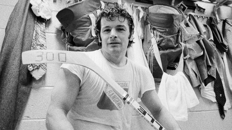 FILE - In this March 25, 1974, file photo, New York Rangers right wing Rod Gilbert displays a hockey stick marked with a "300," the total number of goals he has scored in his career, in the Rangers' locker room in New York. (John Lent/AP)