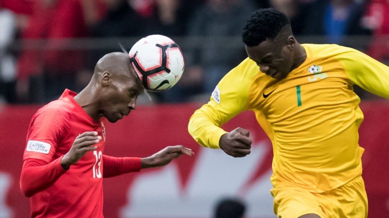 Canada's Atiba Hutchinson, left, gets his head on the ball in front of French Guiana's Soleymann Auguste during the second half of a CONCACAF Nations League qualifying soccer match in Vancouver, on Sunday March 24, 2019. (Darryl Dyck/CP)