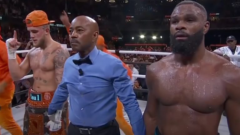 Jake Paul, left, and Tyron Woodley, right, listen to the scorecards being read. Paul won via split decision. (YouTube/BT Sport Boxing)