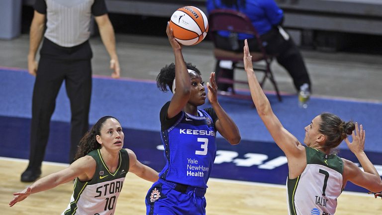 Connecticut Sun guard Kaila Charles shoots over Seattle Storm defender Stephanie Talbot as Sue Bird follows the play during a WNBA basketball game on June 13, 2021. (Sean D. Elliot/The Day via AP)