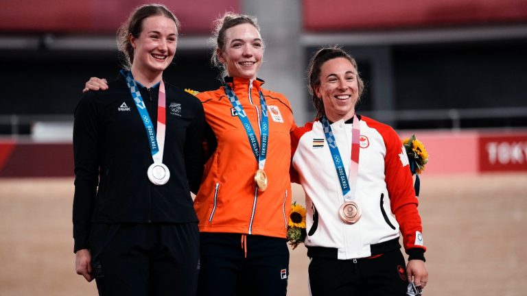 Gold medalist Shanne Braspennincx of Team Netherlands, centre, celebrates on the podium with silver medalist Ellesse Andrews of Team New Zealand, left, and bronze medalist Lauriane Genest of Team Canada, during a medal ceremony for the track cycling women's keirin at the 2020 Summer Olympics, Thursday, Aug. 5, 2021, in Izu, Japan. (Thibault Camus/AP)